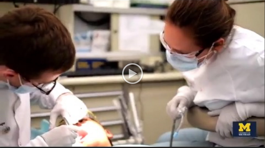 Dentists performing oral exam